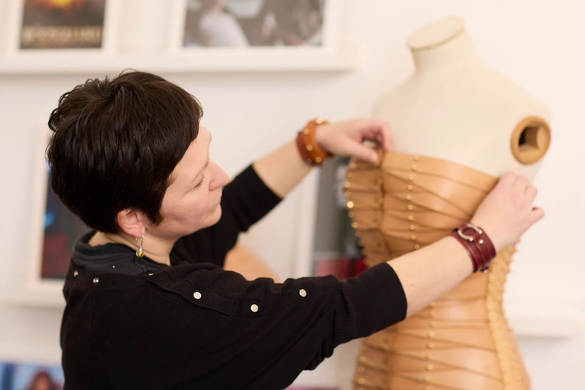 Leather designer Una Burke adjusts the dress she has made on a mannequin on the set of filming a video for her brand with Verver